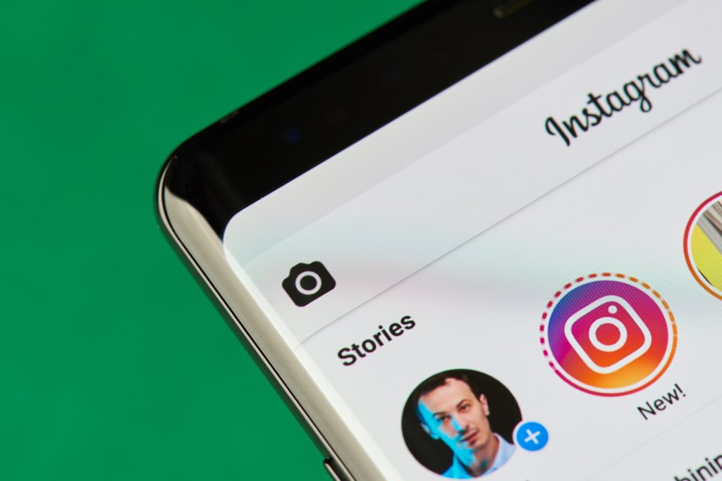 A smartphone displays Instagram Stories